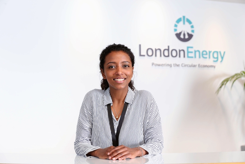 2020 Amani standing in front of LondonEnergy logo 